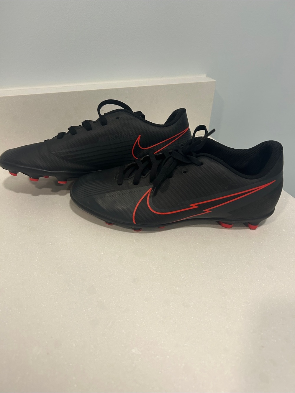 Kids Black Soccer Cleats with Red Accents